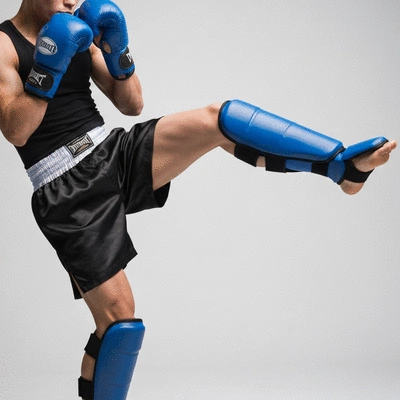 Kickboxing athlete demonstrating technique with shin guards