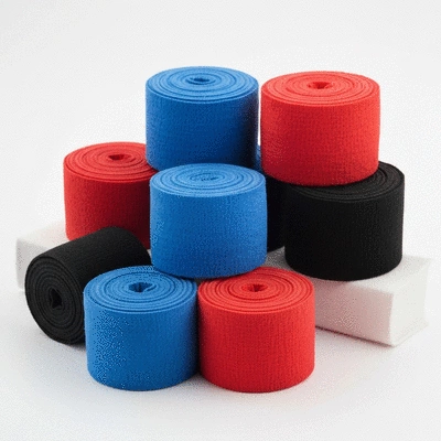 Various boxing bandages in different colors neatly rolled up on a clean background